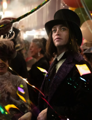 Gothic man in Victorian clothing at a festive carnival scene in Dracula: A Love Tale.
