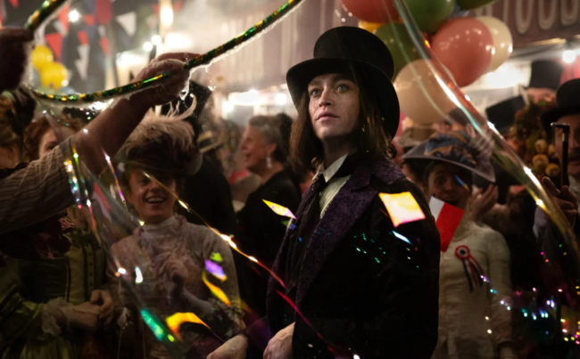 Gothic man in Victorian clothing at a festive carnival scene in Dracula: A Love Tale.