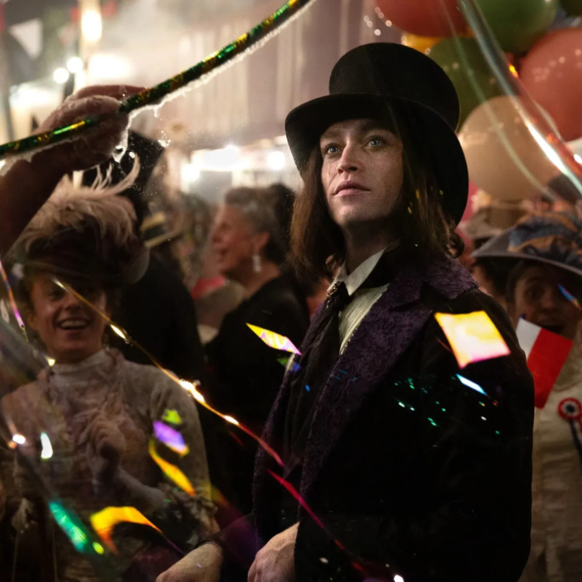Gothic man in Victorian clothing at a festive carnival scene in Dracula: A Love Tale.