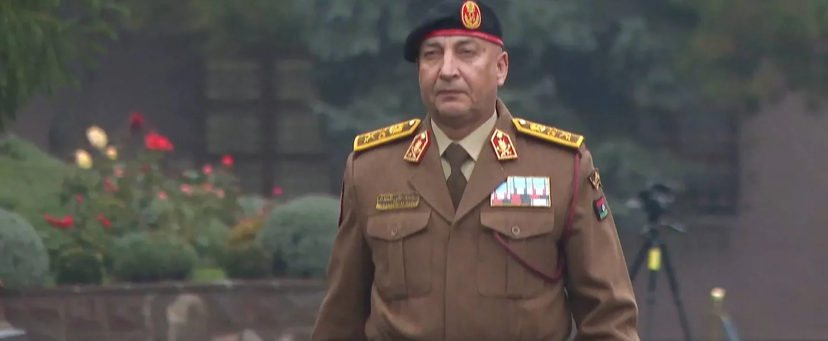 Libyan army chief in military uniform wearing a beret and medals during an official appearance.