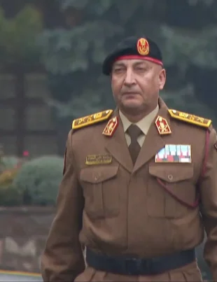 Libyan army chief in military uniform wearing a beret and medals during an official appearance.