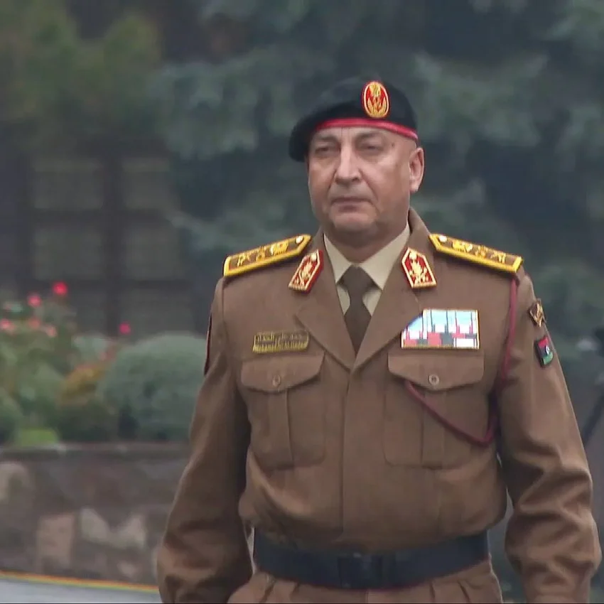 Libyan army chief in military uniform wearing a beret and medals during an official appearance.